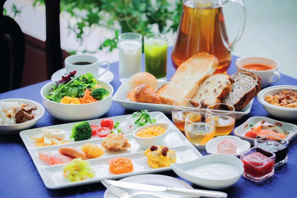 a blue table topped with plates of food and drinks at Sendai Kokusai Hotel in Sendai