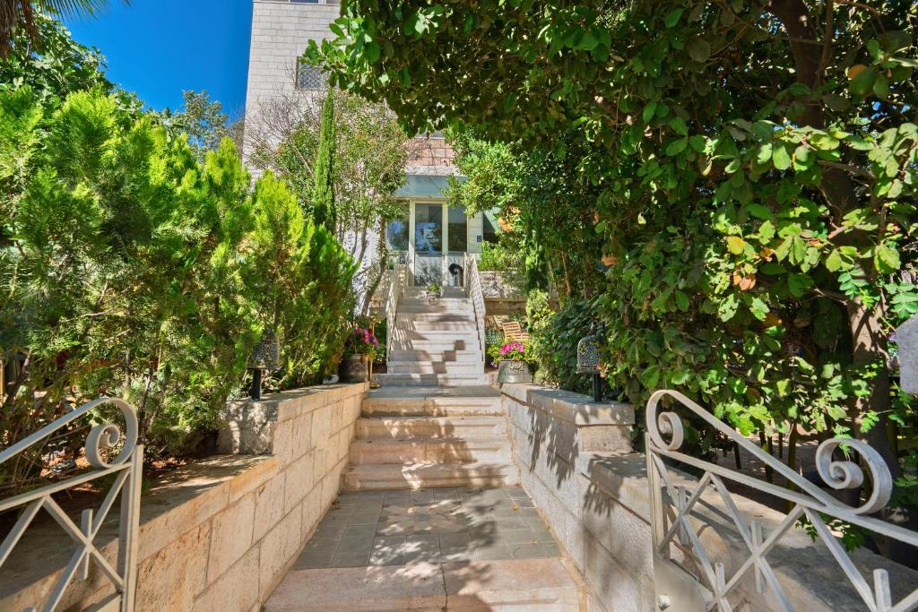 a stairway leading up to a house with trees at Lavender Boutique Hotel in Ramallah