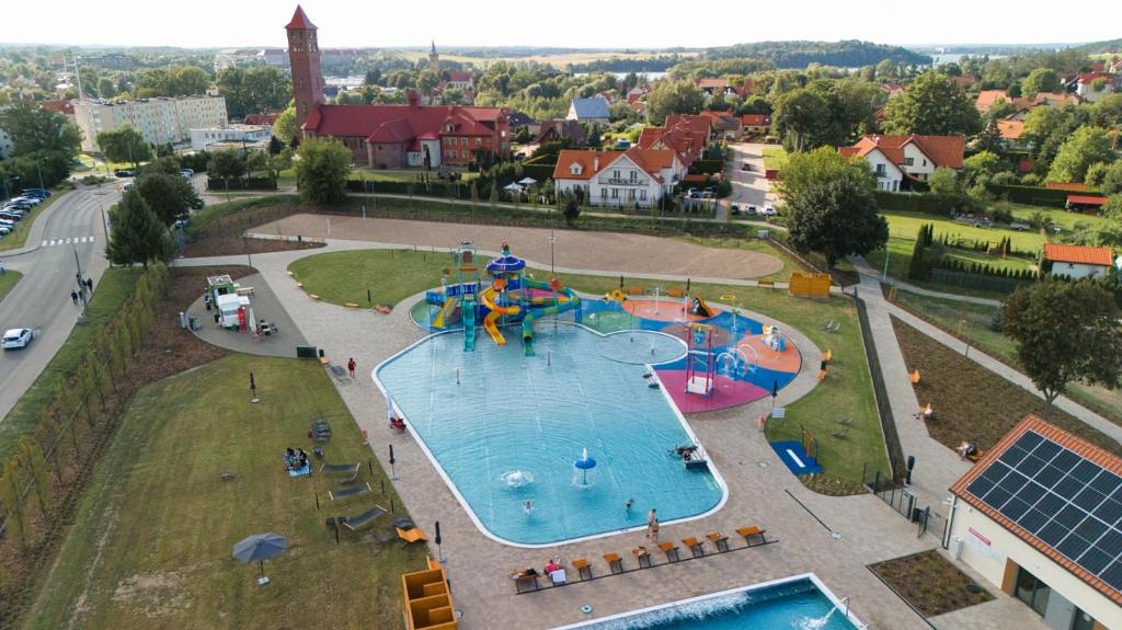 an aerial view of a water park with a water slide at La Rose Residence in Mikołajki