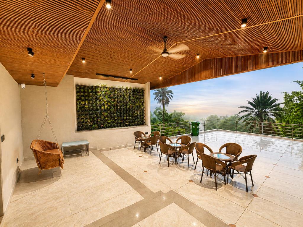 a dining room with tables and chairs and a painting at Grand Valley - A Boutique Resort in Mount Abu in Mount Ābu