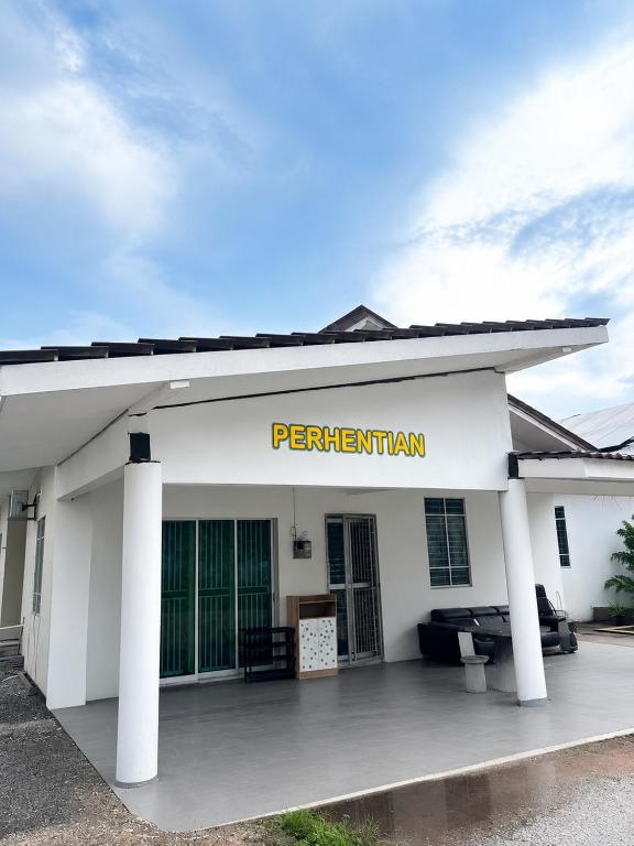 a white building with a sign that reads per testament at Casaria Beach in Paka