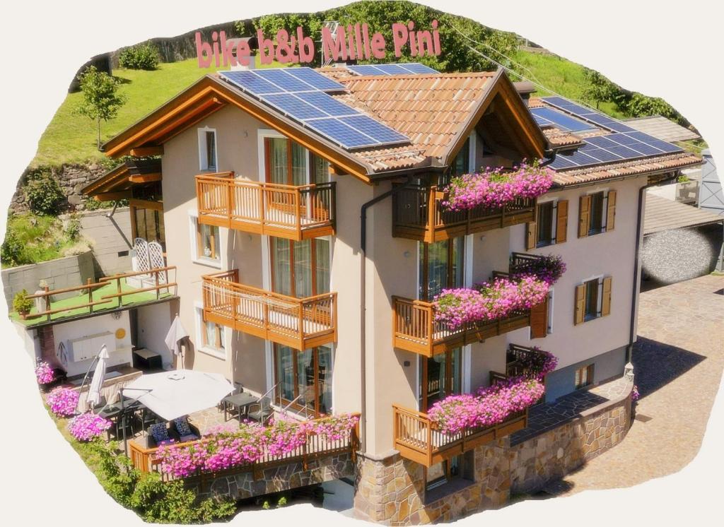 a house with solar panels on the roof at Bike Bed&Breakfast Mille Pini in Baselga di Pinè
