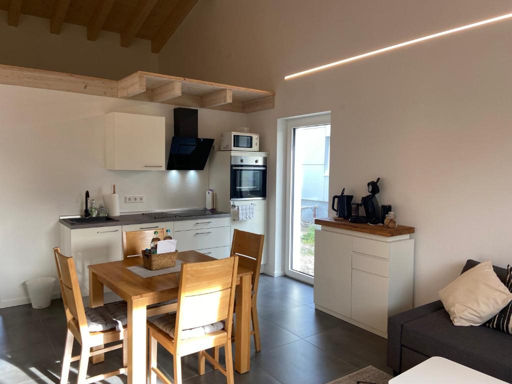 a kitchen and living room with a table and chairs at Ferienwohnung Seeglück in Moos