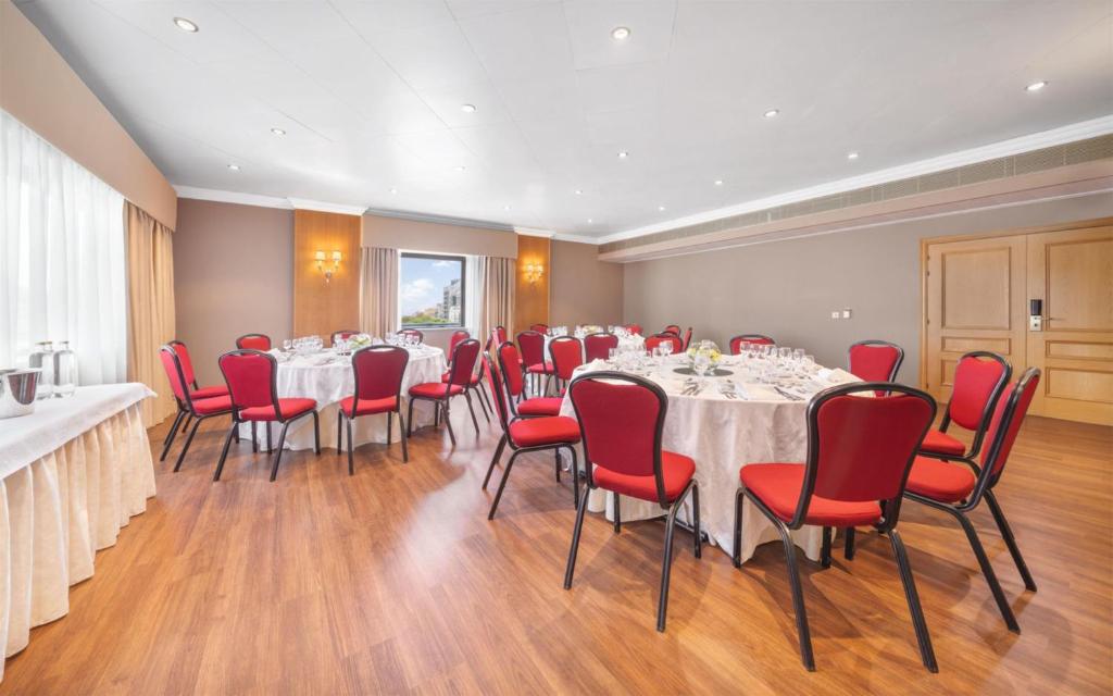 A bright meeting room set for a round-table meal or reception.