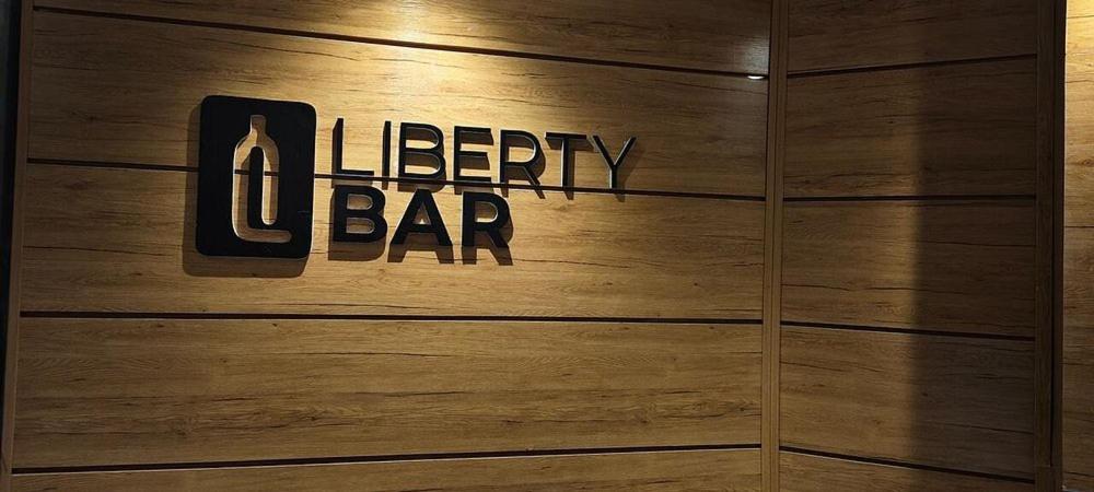 a wooden wall with the words lottery bar on it at Rivona Hotels & Suites in Uyo