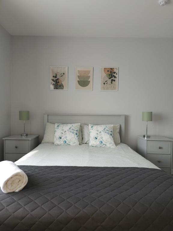 a bedroom with a large bed with two night stands at Cortoon Inn in Tuam