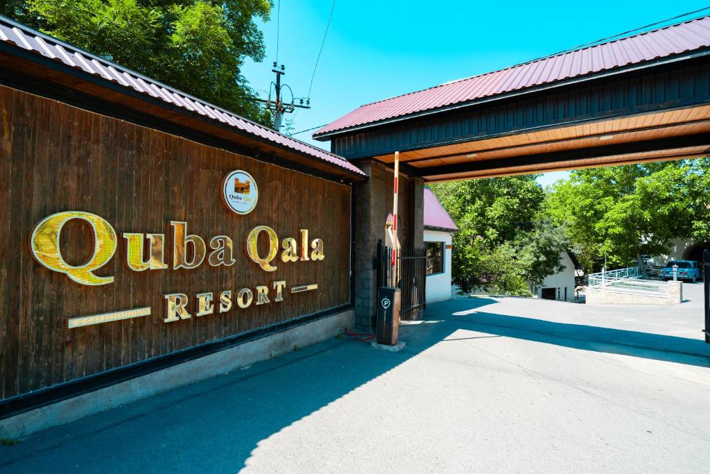 a building with a sign that reads cuba oak resort at Quba Qala Resort in Quba