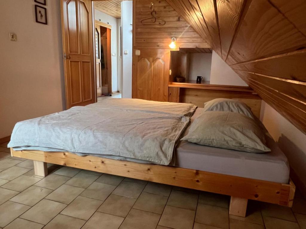 a bed in a room with a wooden bed frame at Bohinj Nook Apartment in Bohinj