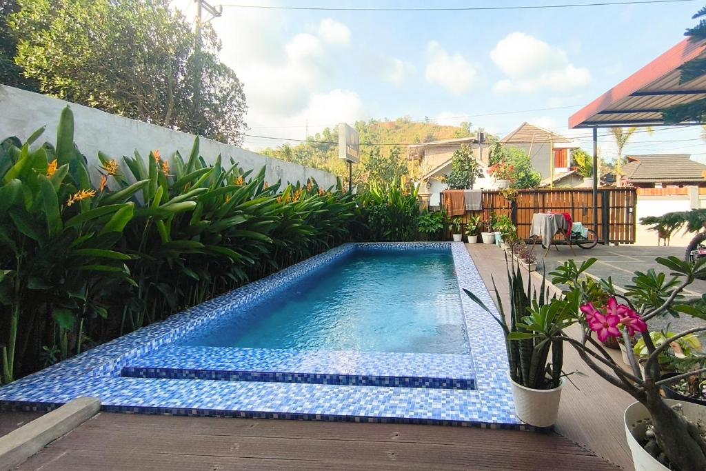 a small swimming pool in a yard with plants at The Lavana Hotel Florida Kuta Mandalika in Kuta Lombok