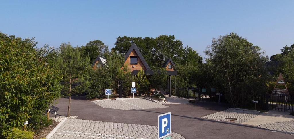 a house with a parking lot in front of it at LES CHALETS DE COYRON. in Coyron