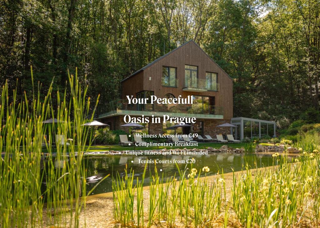 a wooden house with a pond in front of it at Vista Resort & Club in Prague