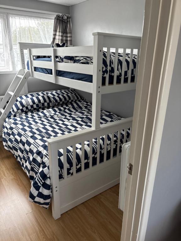 a white bunk bed in a small room at 78 Belle Aire in Hemsby