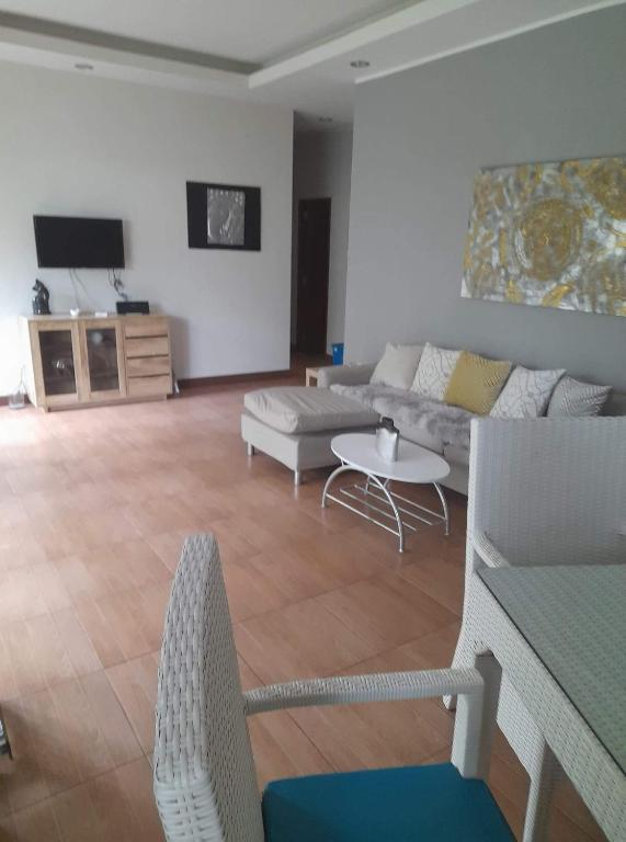 a living room with a couch and a table at Palm Oasis in Nathon Bay