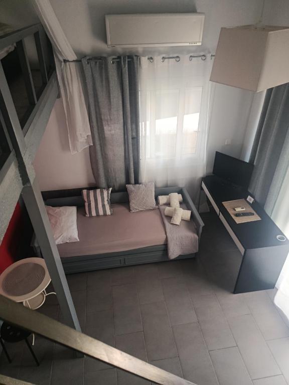a small bedroom with a bunk bed and a window at Irida's House in Xylokastro