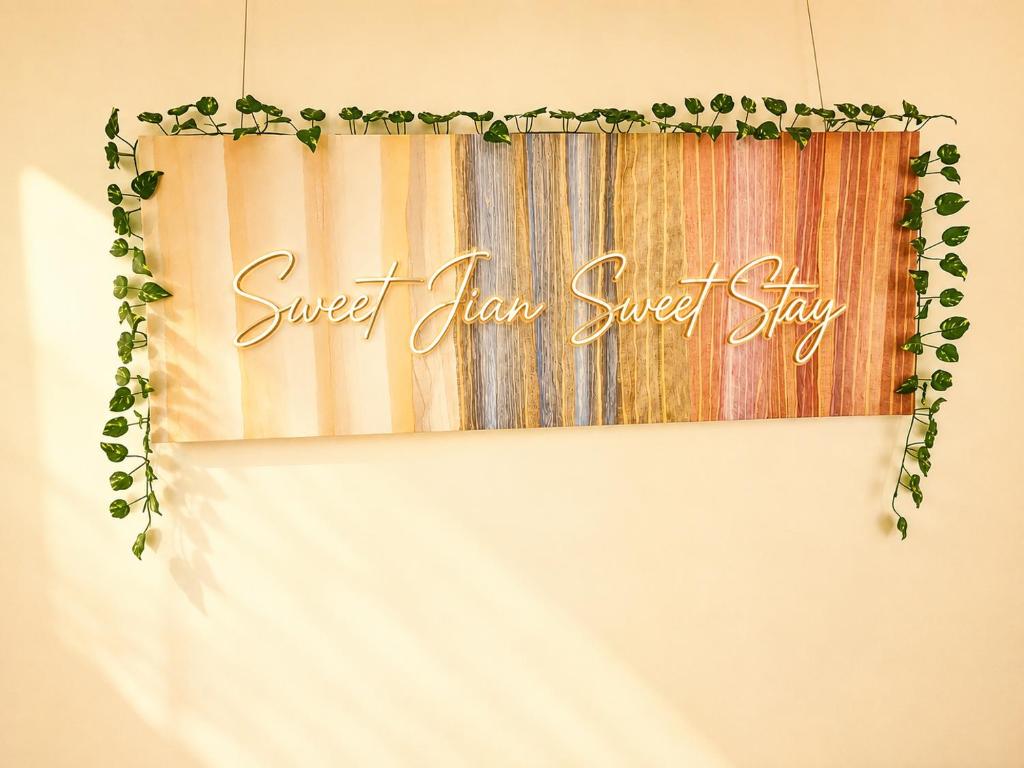 a sign that reads sweet even sugar shop hanging on a wall at SweetJian SweetStay in Suwon