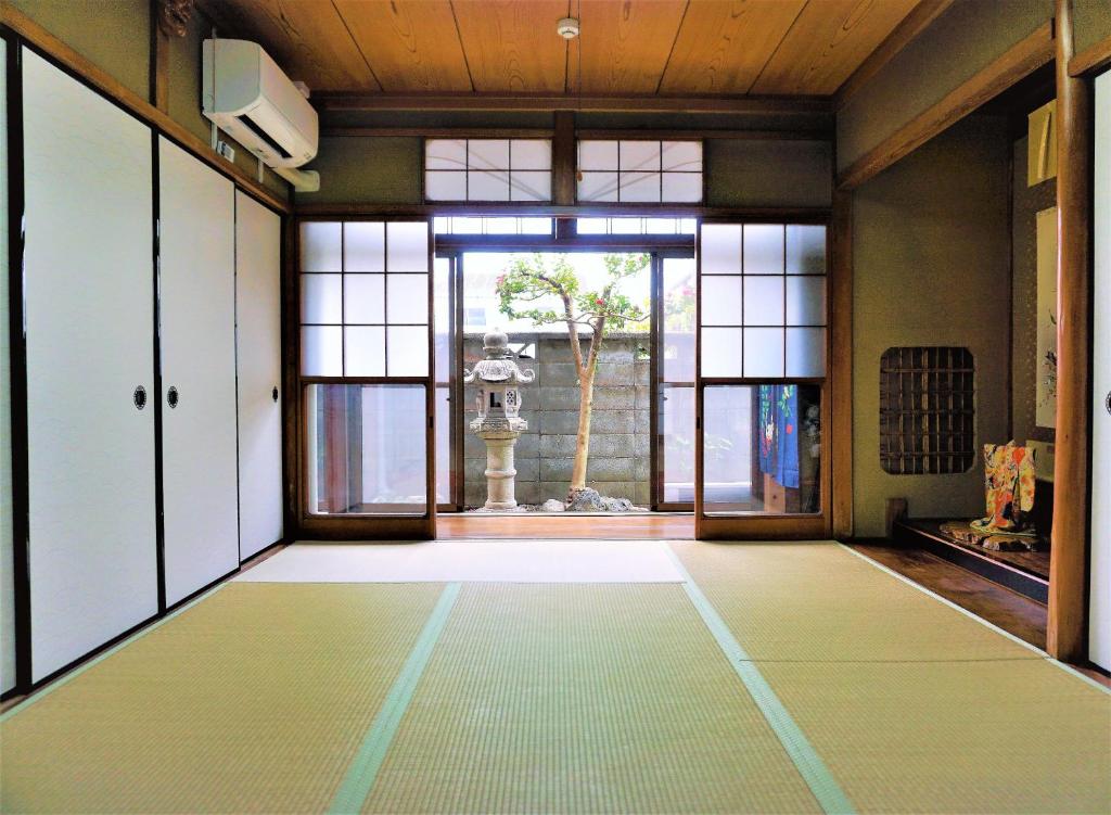 an empty room with a large window at Villa Kyoto Saiin in Kyoto