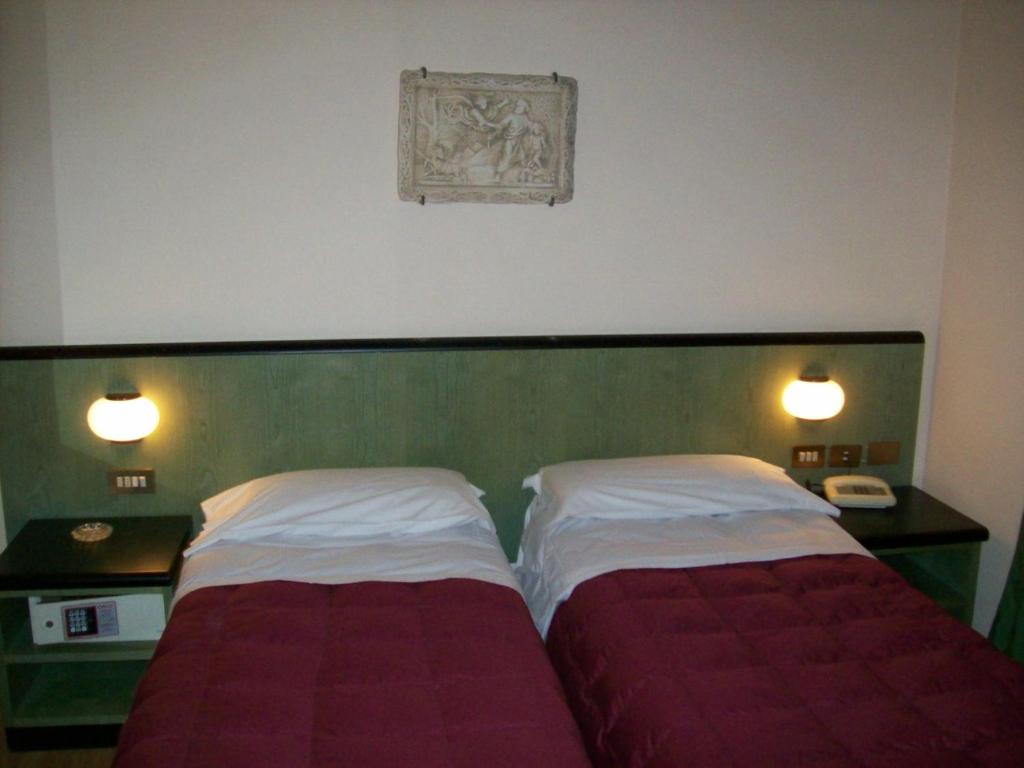 Postel nebo postele na pokoji v ubytování Hotel Prati