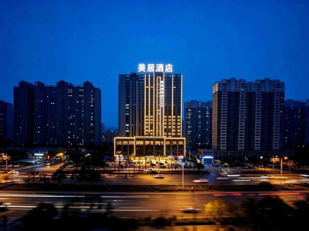 a city skyline with tall buildings at night at Mercure Lanzhou West in Lanzhou