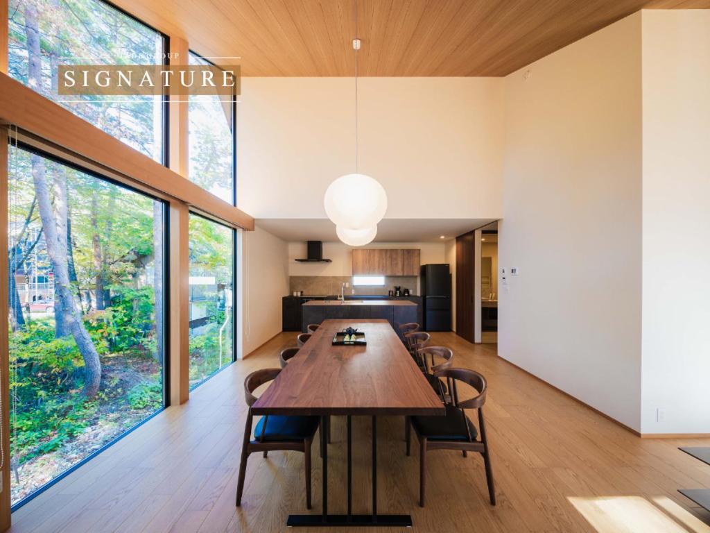 a large dining room with a table and chairs at Kamuy Chalet Hakuba by Jade Villa in Hakuba