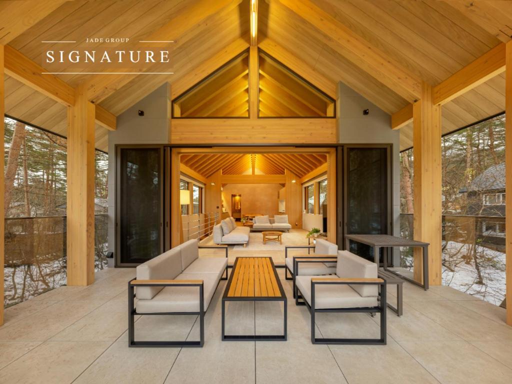 a living room with couches and a table at Lulu Chalet Hakuba by Jade Villa in Hakuba