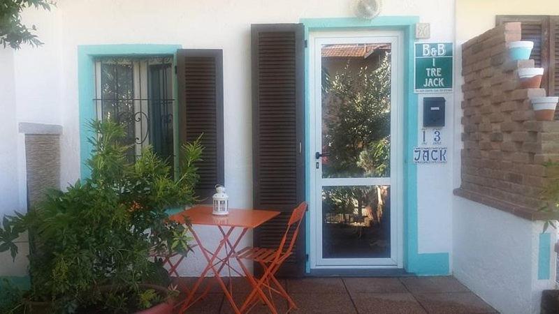 a table and chairs in front of a house with a door at I tre jack Malpensa in Case Nuove