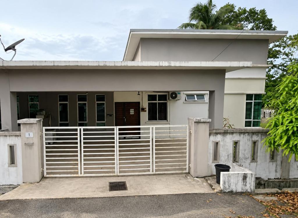a house with a white fence in front of it at Casaria Homestay Cherating in Kampong Baharu Cherating