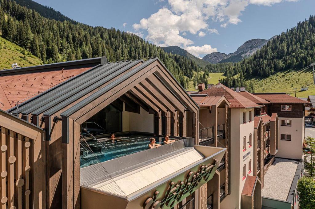 a group of people in a swimming pool on a building at Hotel Zauchenseehof in Zauchensee
