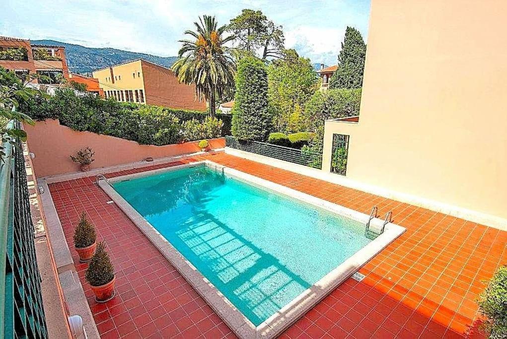 a swimming pool in the backyard of a house at Saint Jean Cap Ferrat in Saint-Jean-Cap-Ferrat