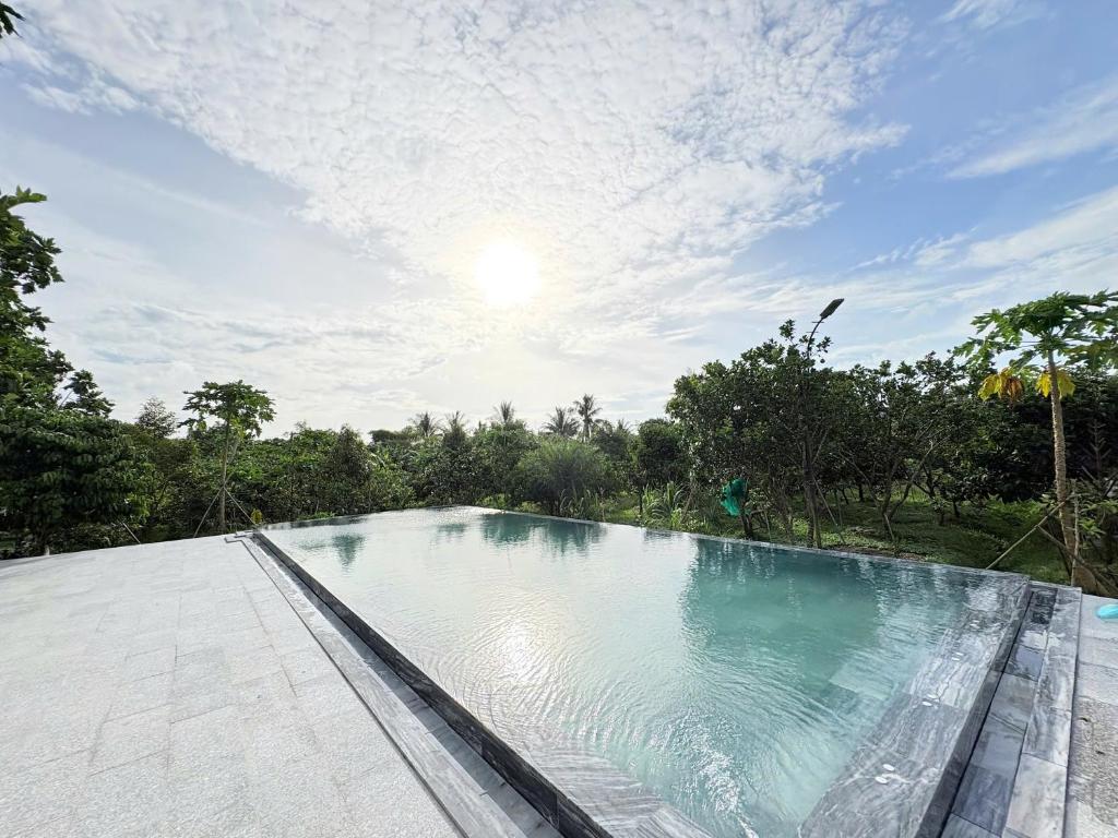 a swimming pool on the roof of a house at Orchard Fruit Farm Bungalow in Phú Quốc