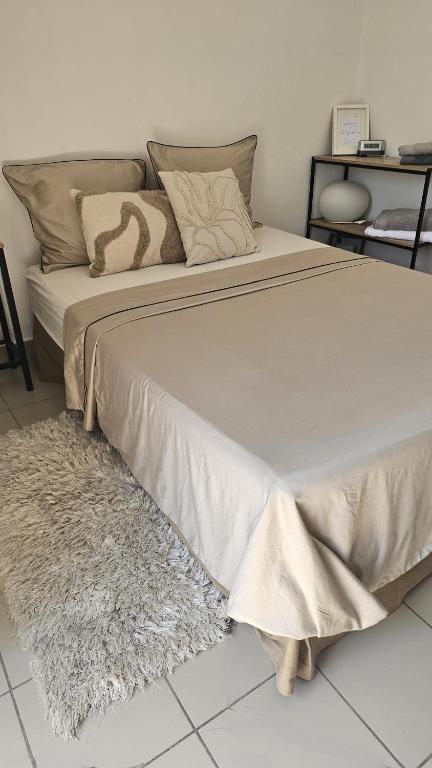 a bedroom with a large bed and a rug at Studios Corte Restonica in Corte