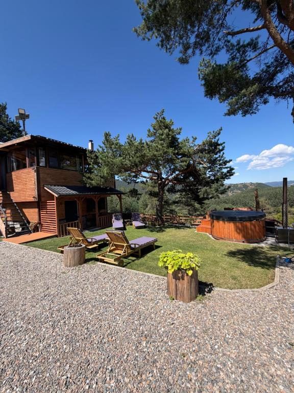 a backyard with a log cabin and a patio at Villa INDIANA Devin in Devin