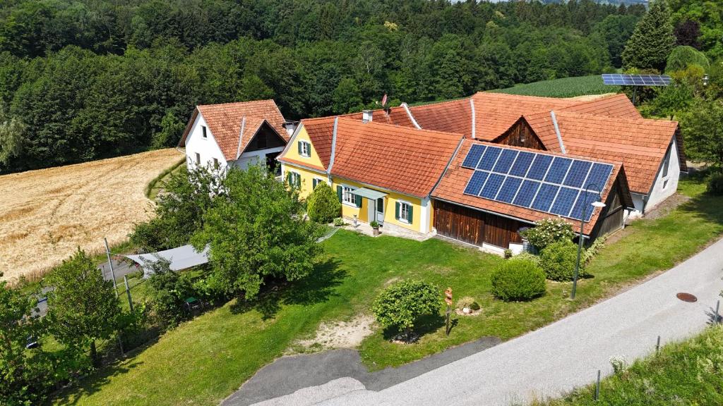 an aerial view of a house with solar panels on the roof at Ferienhaus Planetz in Kaindorf