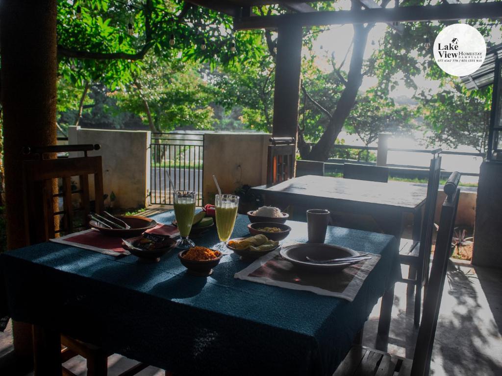 a blue table with food and drinks on it at Lake View Dambulla in Dambulla