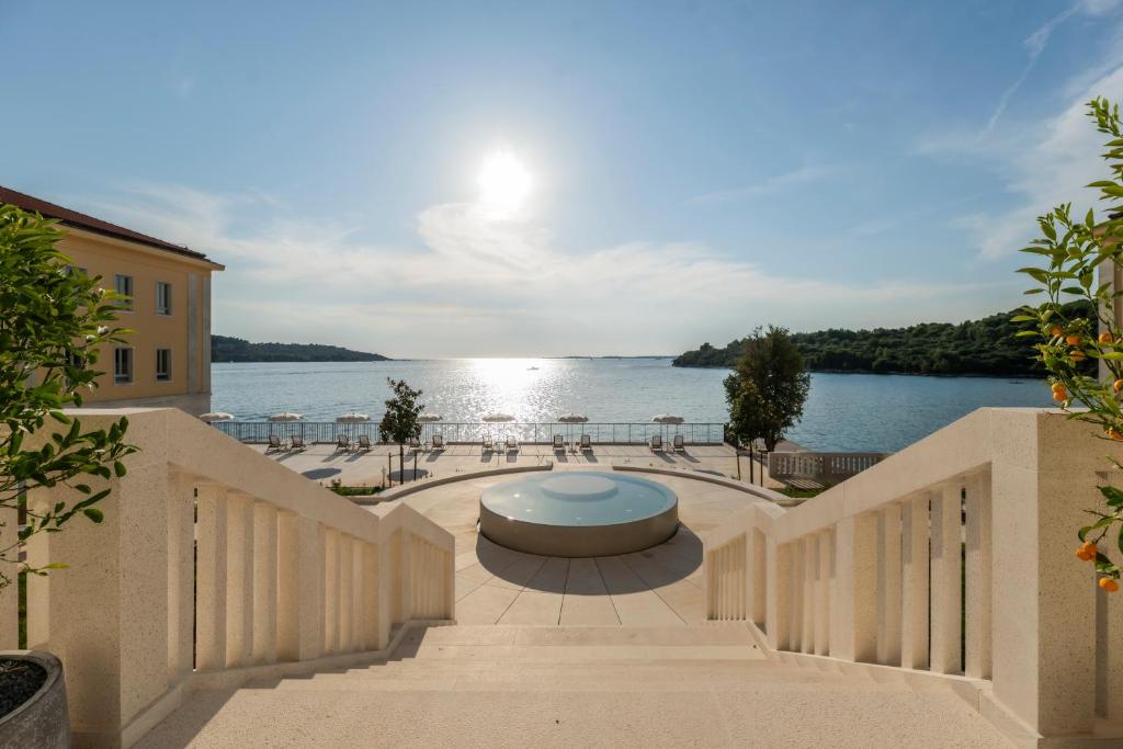 a view of the water from the balcony of a building at Monumenti Heritage Hotel&Resort in Pula