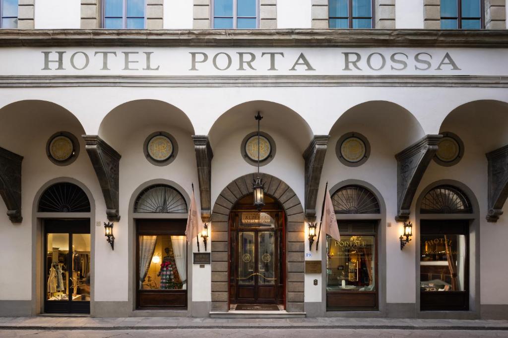 a hotel portal with clocks on the front of a building at Porta Rossa Hotel Firenze, Colbert Collection in Florence