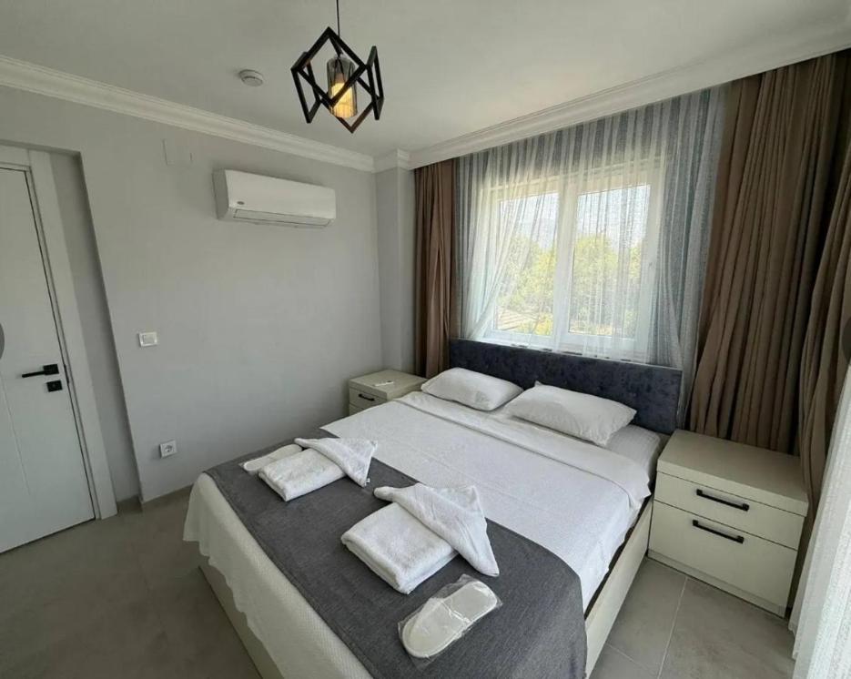 a bedroom with a large bed with towels on it at Sever Apart in Gaziantep