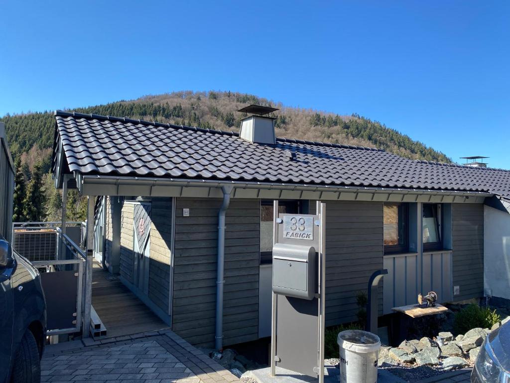 a house with a roof with a for sale sign on it at Hochheide Lodge in Winterberg