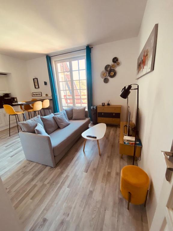 a living room with a couch and a table at Le Petit Condette in Condette