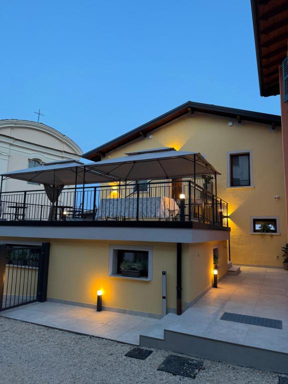 a large building with a balcony with a deck at B&B Casa Olivia in Gardone Riviera