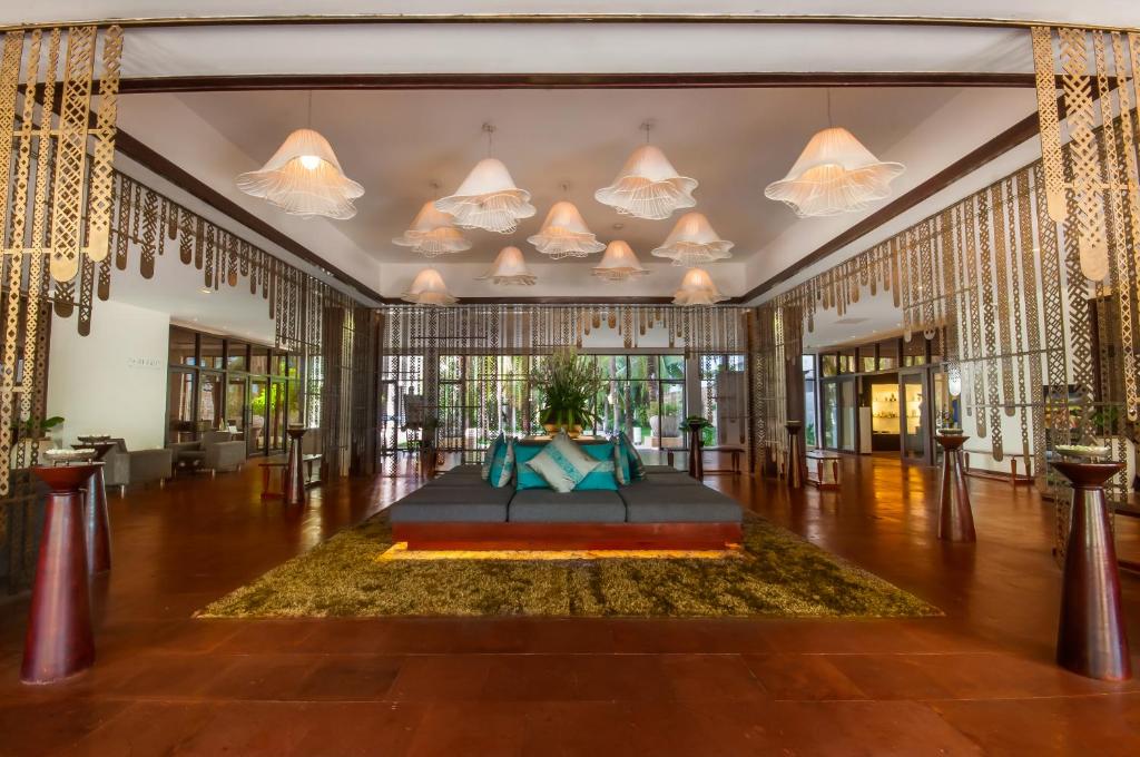 a lobby with a table in the middle of a room at Lotus Blanc Resort in Siem Reap