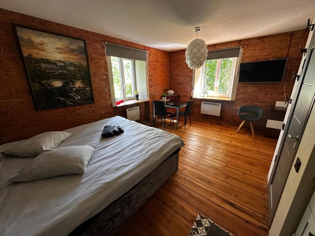 a bedroom with a large bed and a table with chairs at R.Wolf castle in Gulbene