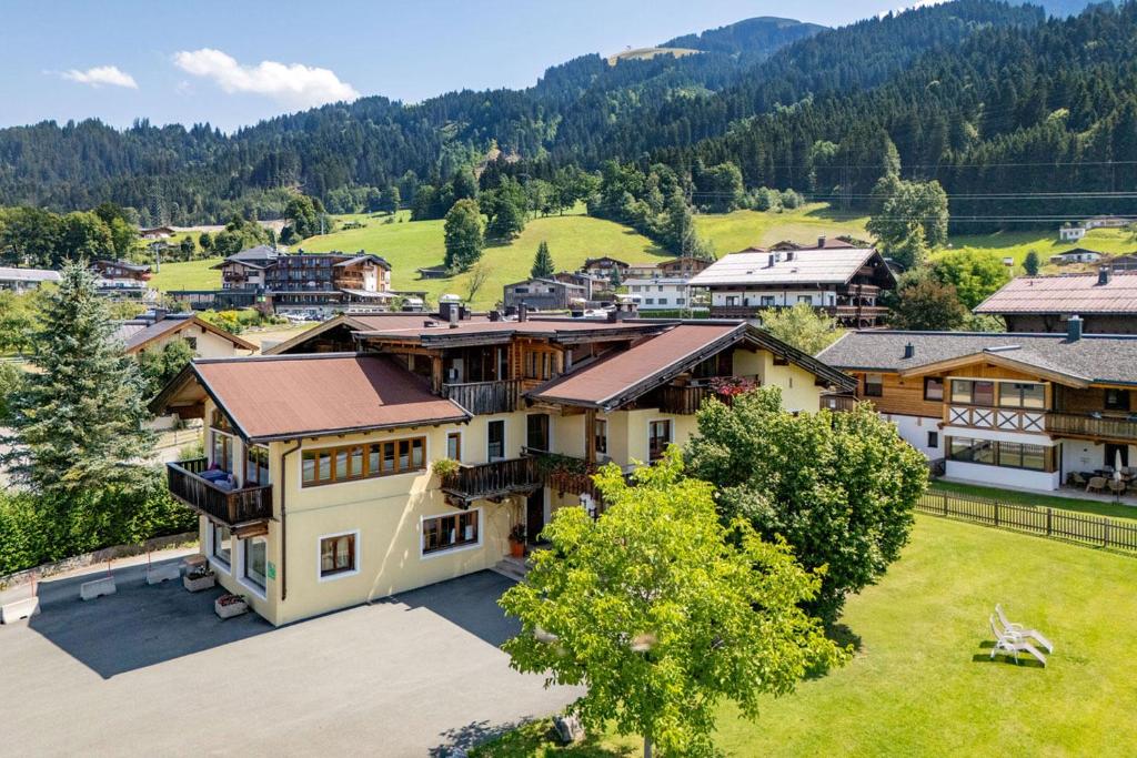 an aerial view of a large house in a village at Appartements am Römerweg in Oberndorf in Tirol
