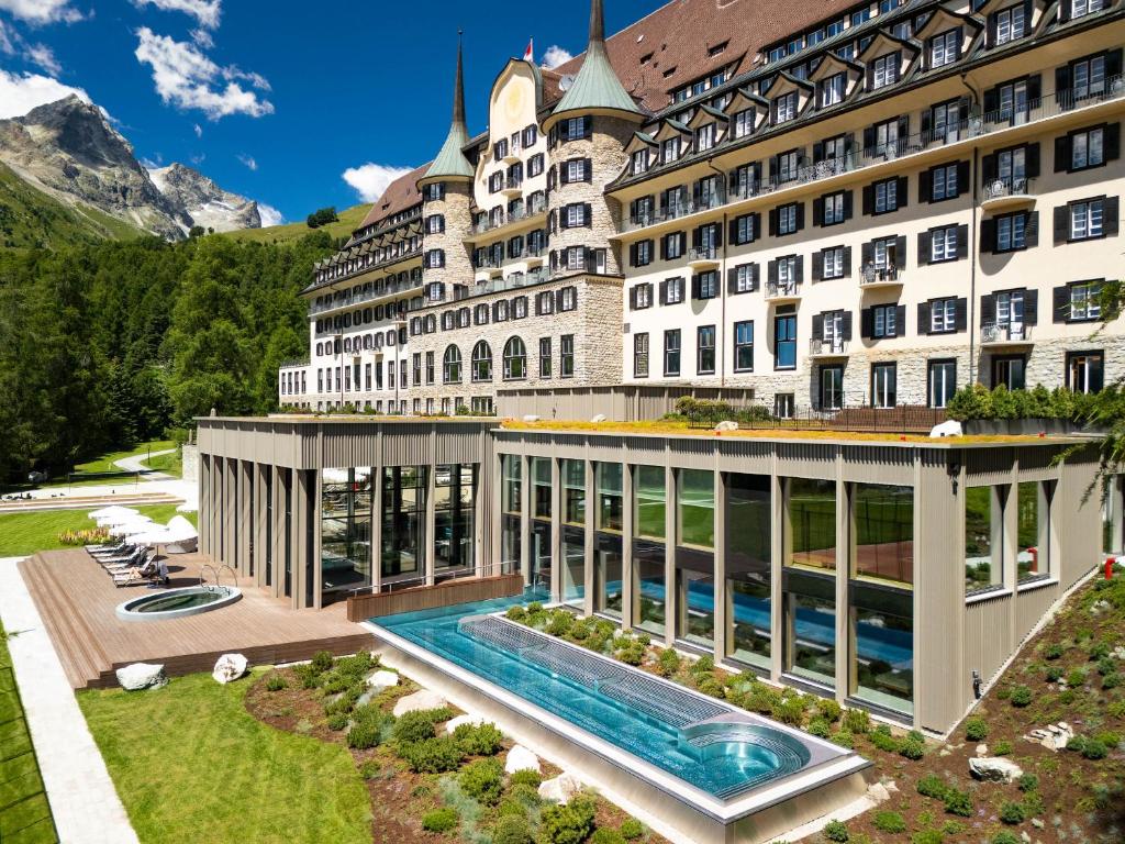 an image of a hotel with a swimming pool at Suvretta House in St. Moritz