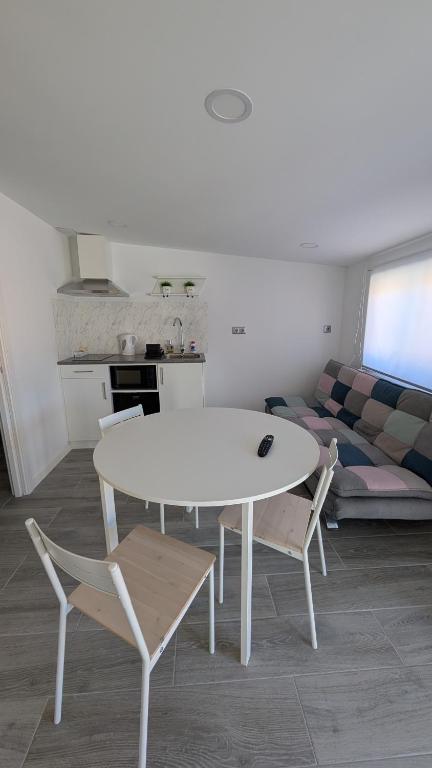 a white table and chairs in a room with a couch at Praciña do olvido in Cee