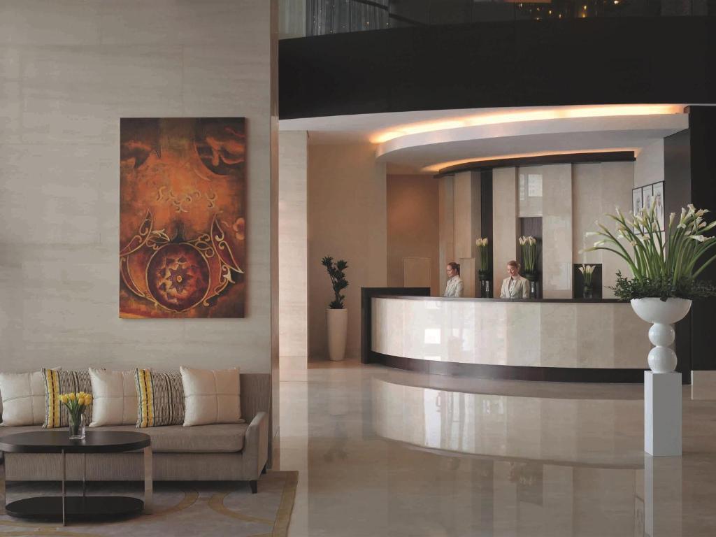 a lobby of a hotel with a couch and a mirror at Mövenpick MS Sunray in Luxor