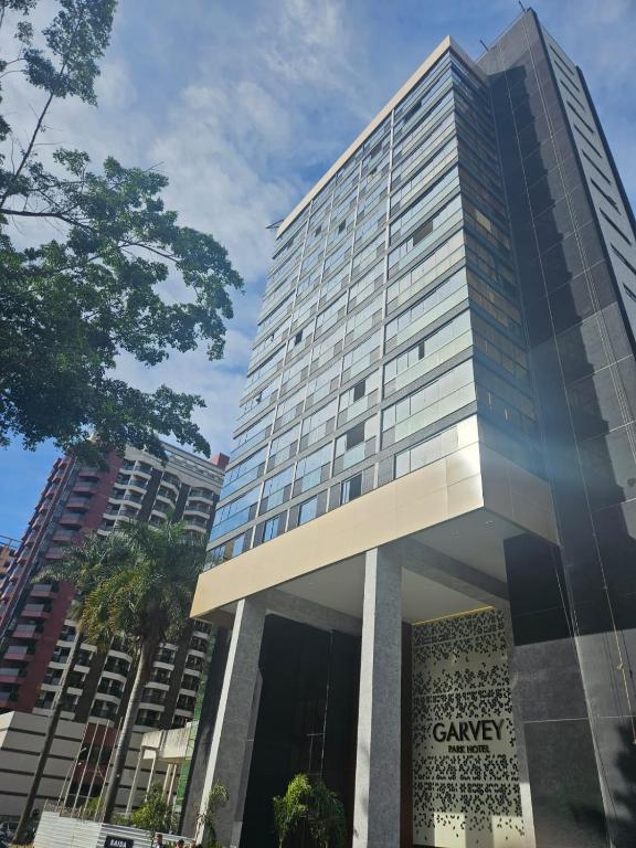 a tall building with a sign in front of it at Dellos Apart Hotel e Administração LTDA in Brasília