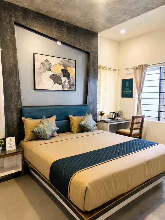 a bedroom with a large bed in a room at Srj's Thaneesh Residency in Ooty