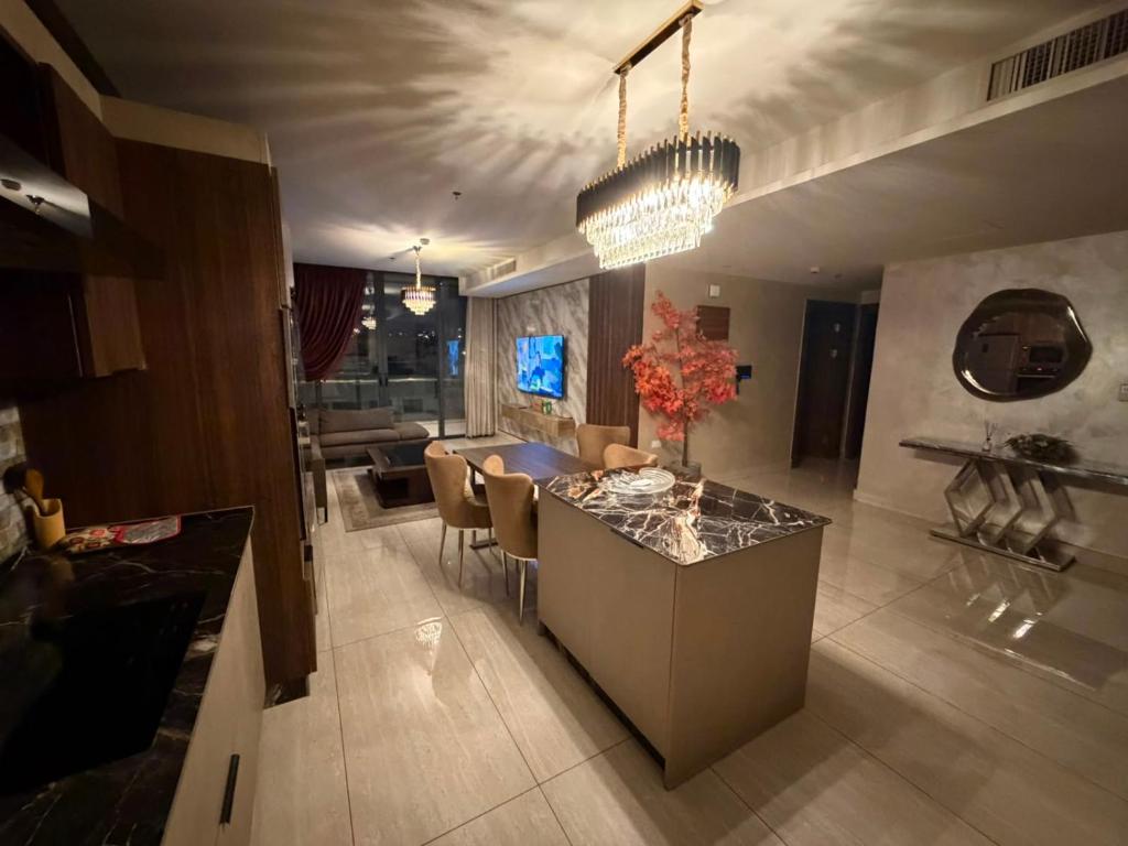 a kitchen and living room with a table and chairs at Nine homes in Amman