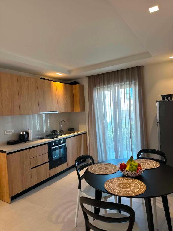 a kitchen and a table with a bowl of fruit on it at Nestia Residences in Kardamaina