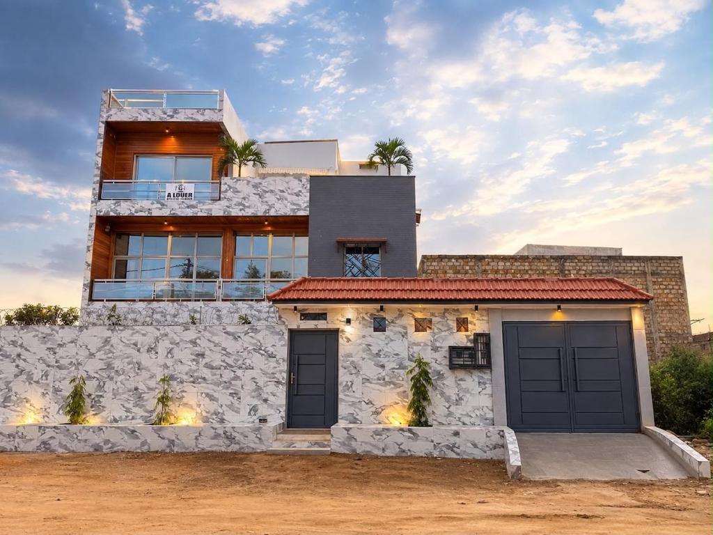 a house with two garage doors in front of it at house for rent in Saly Portudal